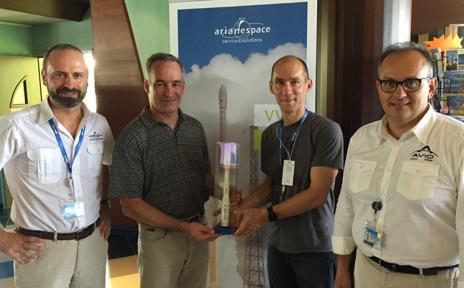 Giulio Ranzo and Avio emploees with a Vega launcher miniature