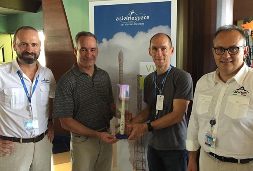 Giulio Ranzo and Avio emploees with a Vega launcher miniature